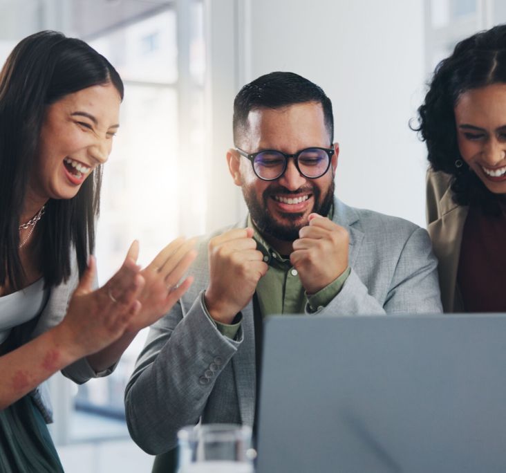 People, employee and excited  in office with laptop for good news, celebration and happy. Business, teamwork and collaboration with smile for bonus, target and project success on email in boardroom.